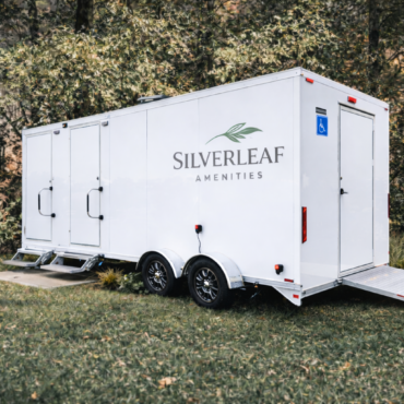 Accessible luxury restroom trailer with ramp by Silverleaf Amenity for outdoor events and venues.