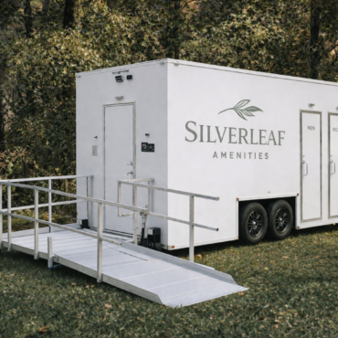 Accessible luxury restroom trailer with ramp by Silverleaf Amenity for outdoor events and venues.