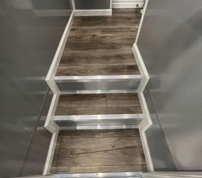 Interior view of restroom trailer steps with non-slip flooring leading to restroom area, designed for safe use at Colorado events and job sites