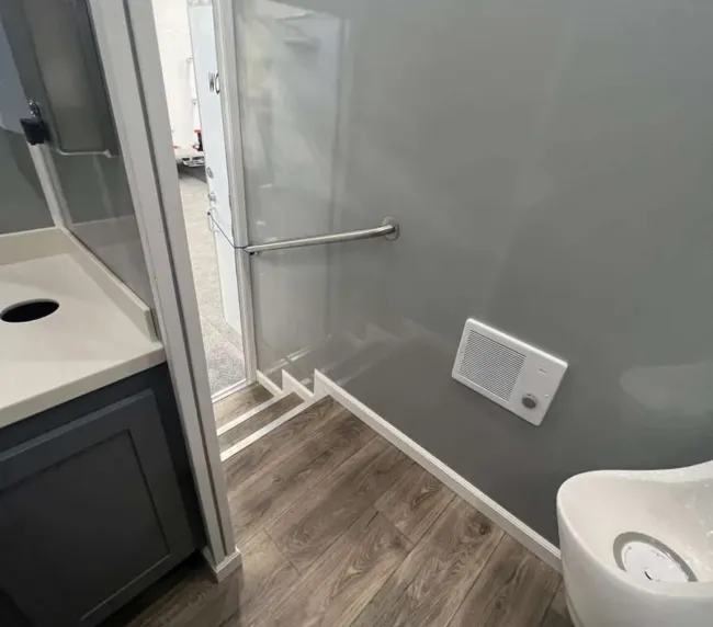 Accessible interior with grab bar and spacious layout inside Silverleaf Amenities ADA restroom trailer