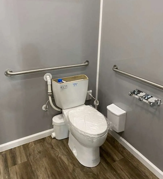 ADA-compliant restroom trailer interior with toilet, grab bars, and accessible layout for event and construction rentals in Colorado