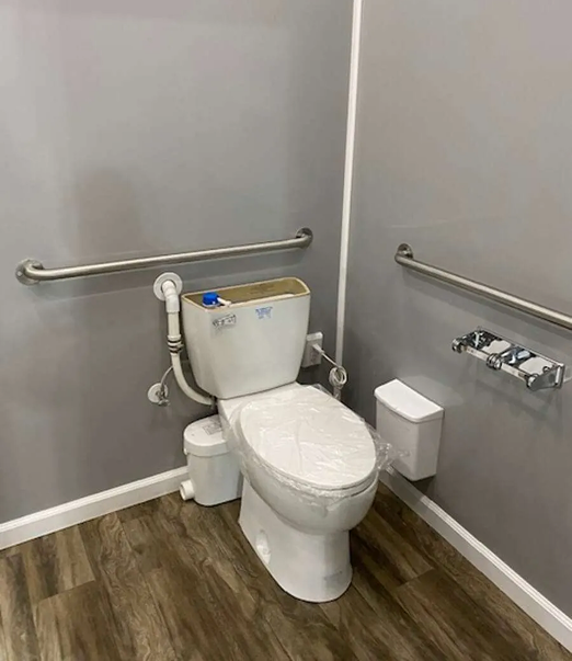 ADA-compliant restroom trailer interior with toilet, grab bars, and accessible layout for event and construction rentals in Colorado