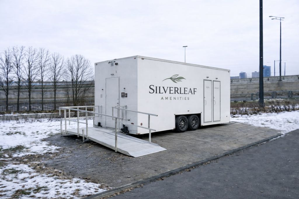 ADA restroom trailer with wheelchair ramp set up outdoors in winter by Silverleaf Amenities in Colorado