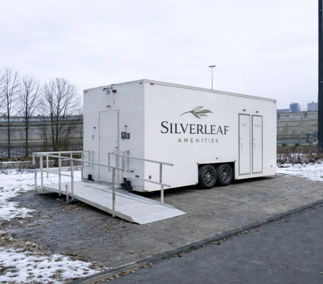 ADA restroom trailer with wheelchair ramp set up outdoors in winter by Silverleaf Amenities in Colorado