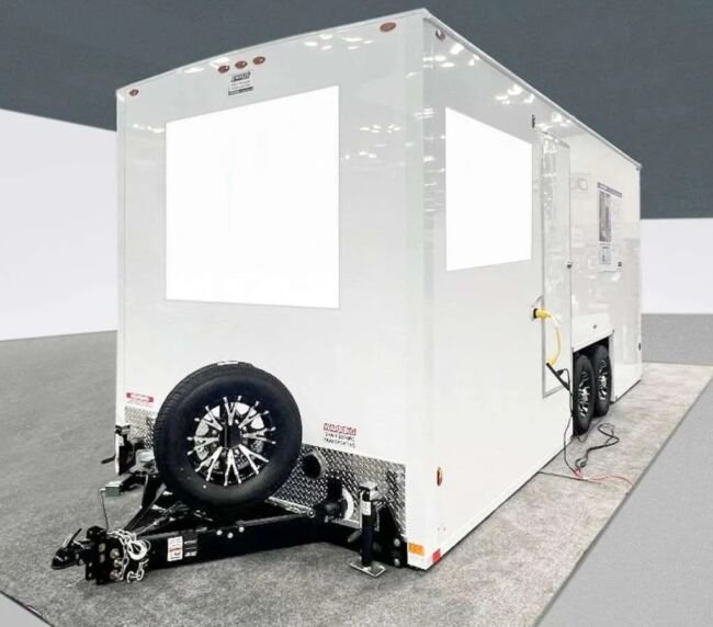 Exterior side view of a portable restroom trailer with power hookup, available for event and construction rentals in Colorado
