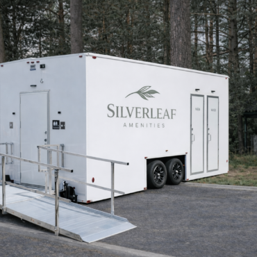 Luxury ADA-compliant restroom trailer with ramp by Silverleaf Amenities, available for events and job sites across Colorado