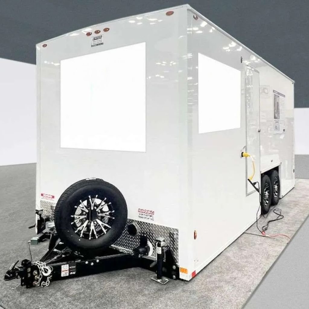 Exterior side view of a portable restroom trailer with power hookup, available for event and construction rentals in Colorado